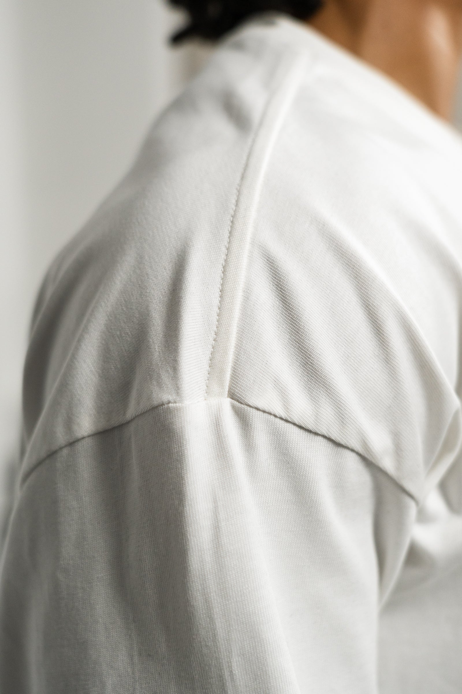 KHAIR Foundations off-white T-shirt shoulder seam detail
