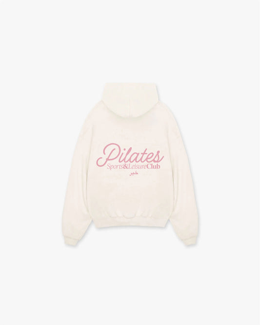 Back view of Khair Pilates Sports & Leisure Club hoodie in butter cream featuring large pink logo across the shoulders.