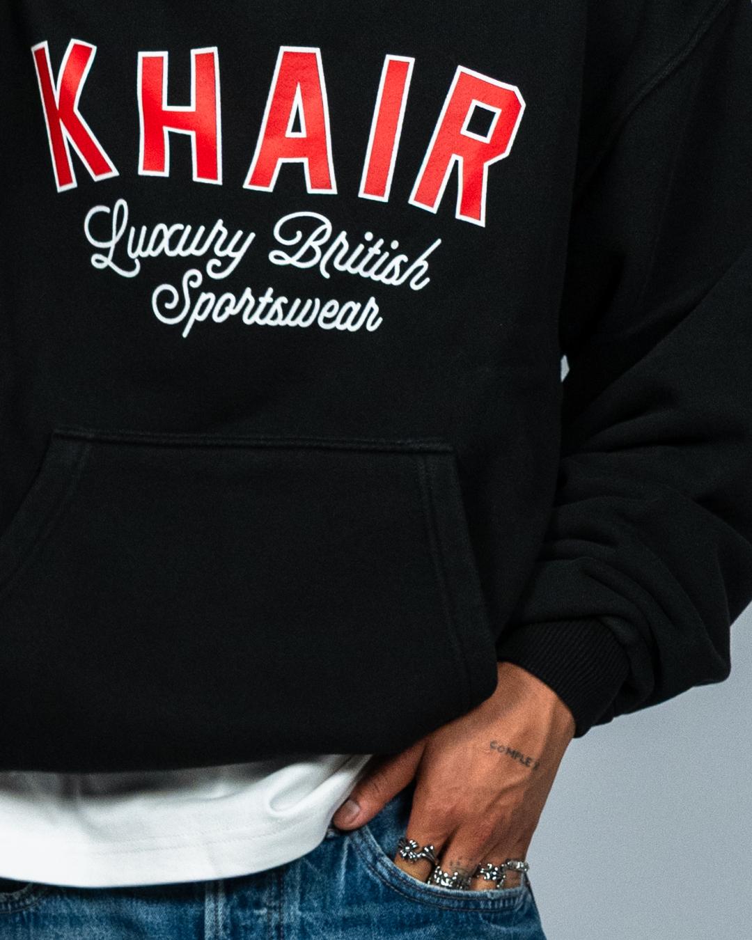 KHAIR oversized washed-black hoodie chest graphic detail